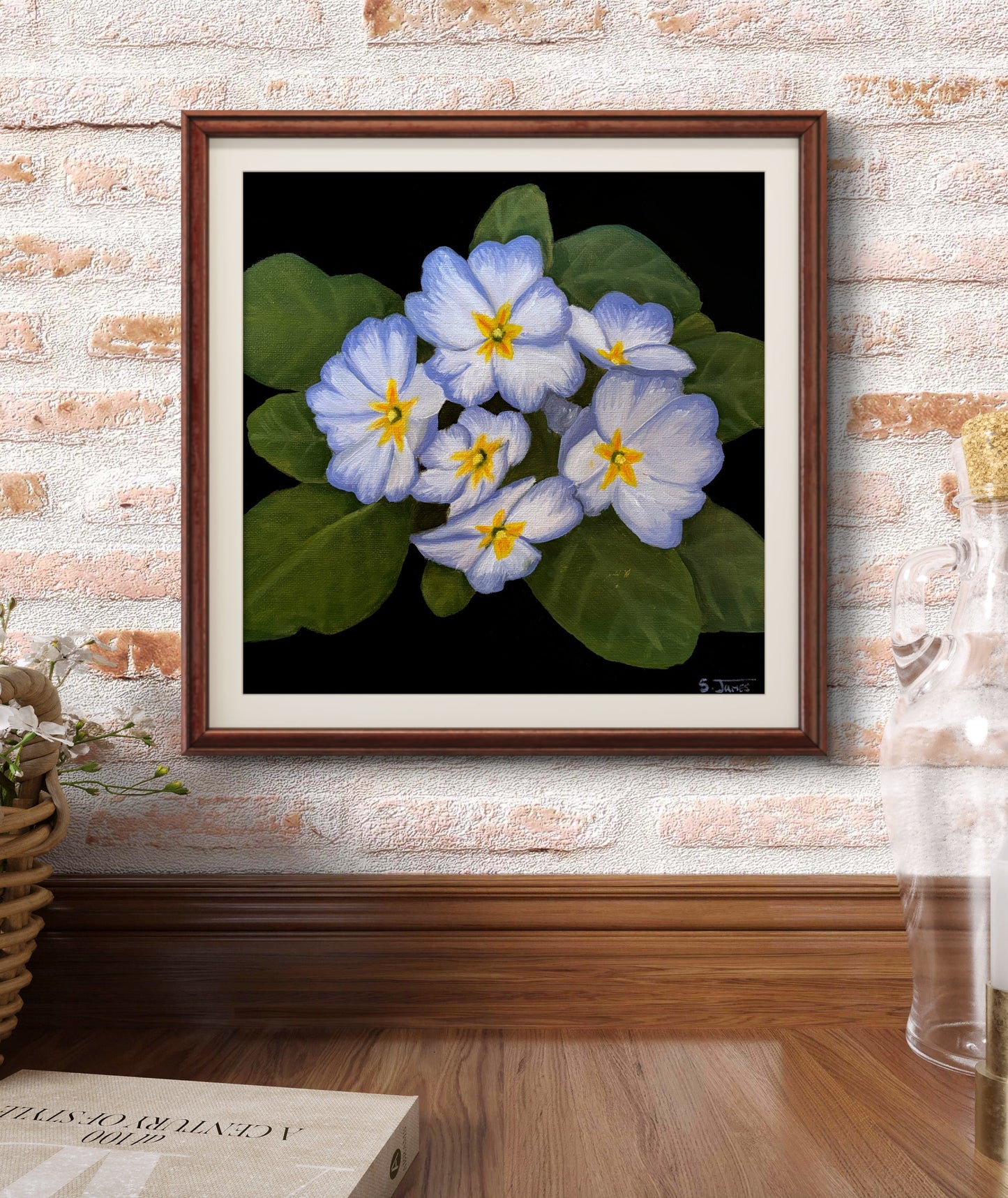 Framed artwork of blue flowers on a brick wall with 'Frameit' branding.