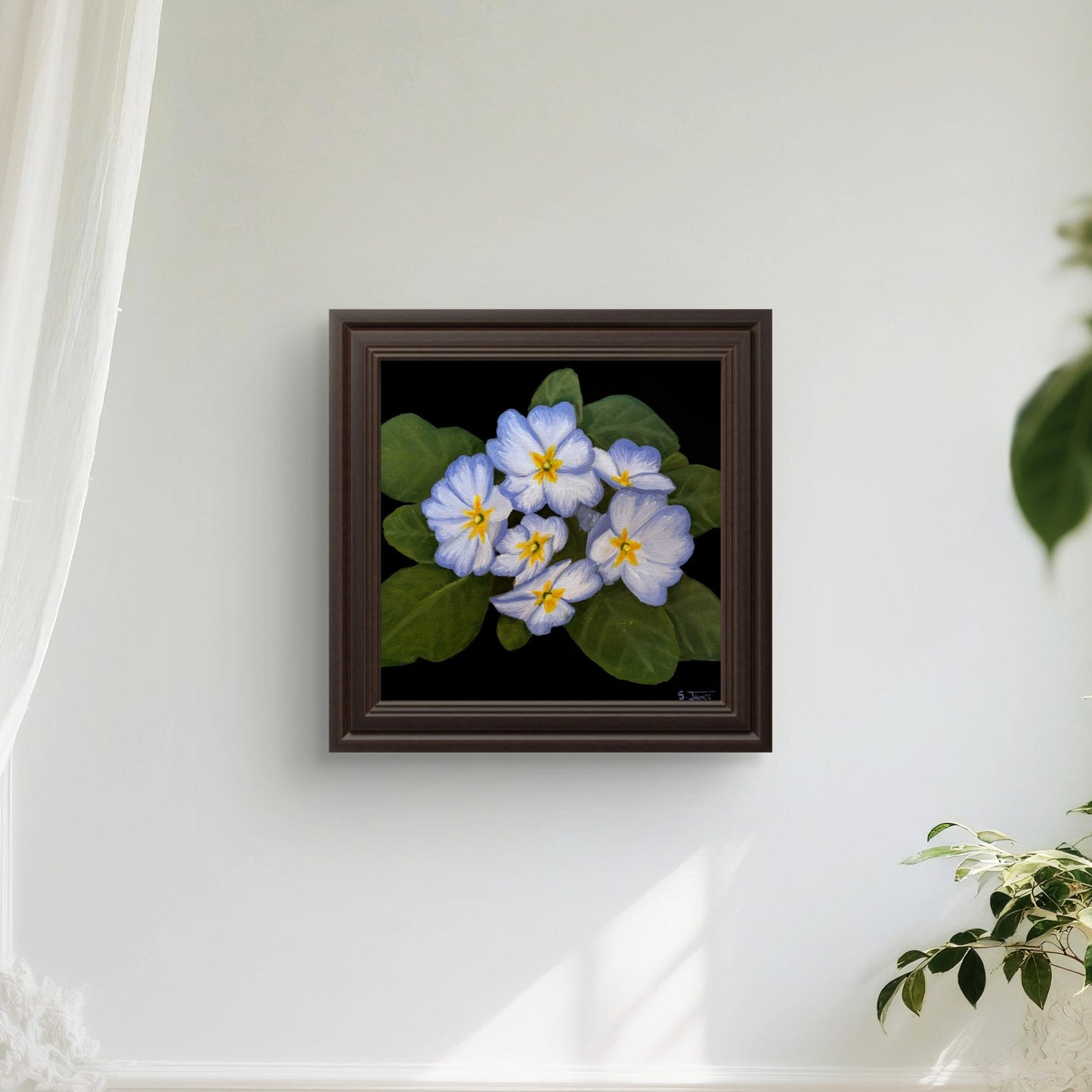 Framed artwork of flowers on a white wall with curtains and plants.
